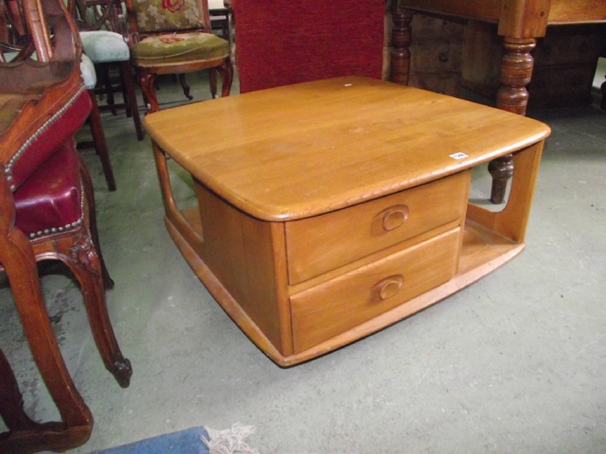 Appraisal: An Ercol light elm 'Pandora's Box' coffee table with moulded