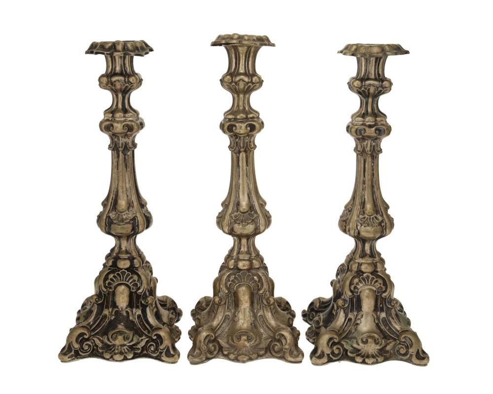 Appraisal: Three Continental silver candlesticks th Century Appear unmarked Each hollow