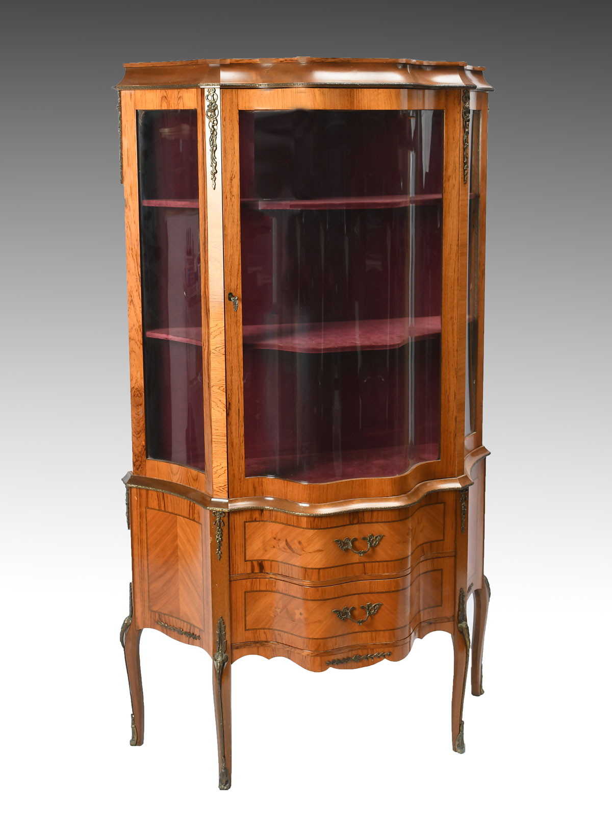 Appraisal: ITALIAN SATINWOOD SERPENTINE VITRINE Velvet lined shelf interior over drawers