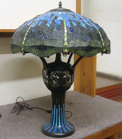 Appraisal: A LEADED GLASS AND PATINATED BRONZE DRAGONFLY TABLE LAMP having