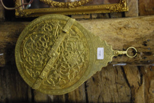 Appraisal: An Arabic brass astrolabe profusely engraved containing three navigation disks