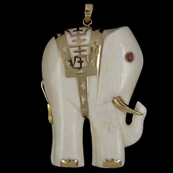 Appraisal: k Ivory Elephant Pendant with Ruby Eye k yellow gold