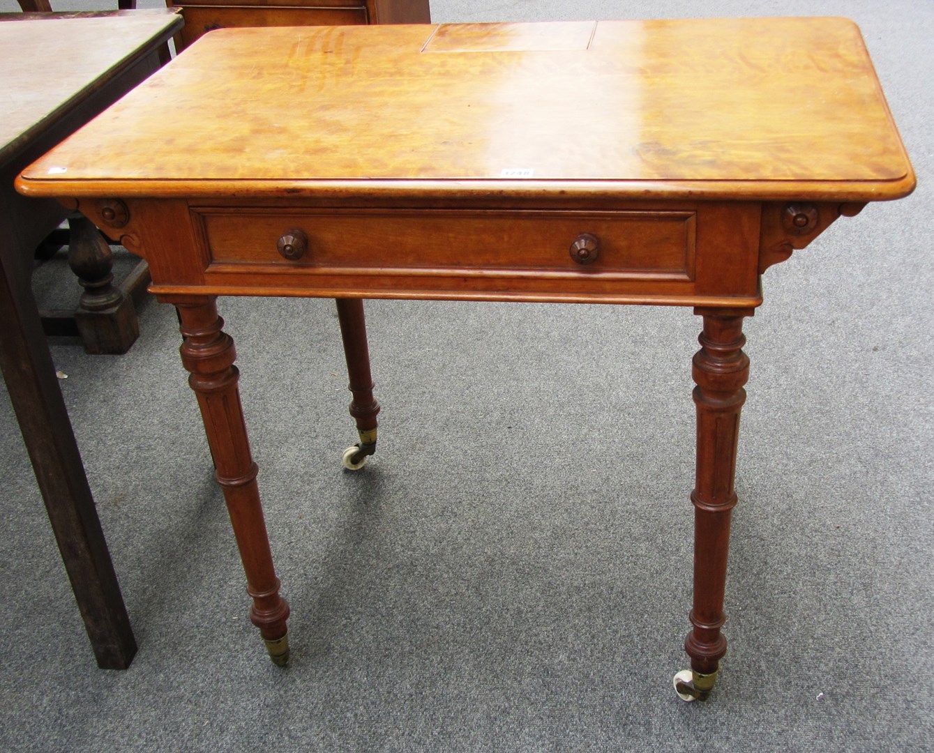 Appraisal: A Victorian satinwood writing table with pop up stationery compartment