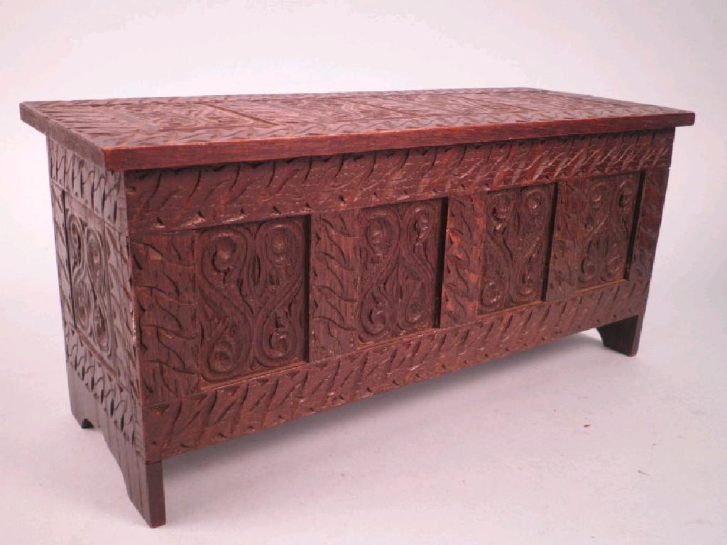 Appraisal: A miniature carved oak four panel coffer on fishtail end