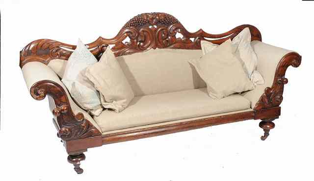 Appraisal: A TH CENTURY MAHOGANY SOFA with fruiting vine and scroll