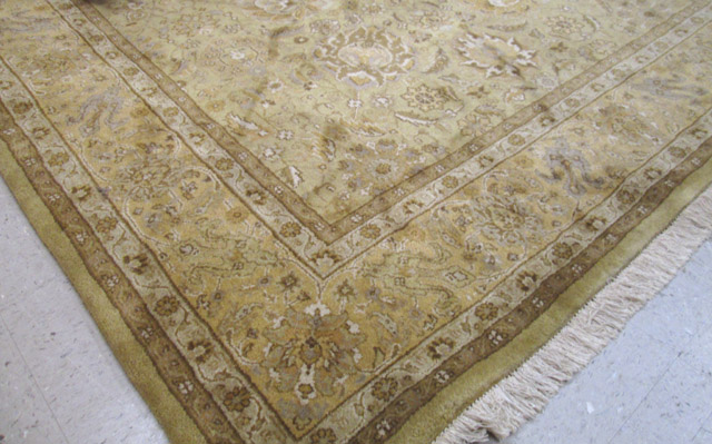 Appraisal: HAND KNOTTED ORIENTAL CARPET Indo-Persian overall floral design on khaki