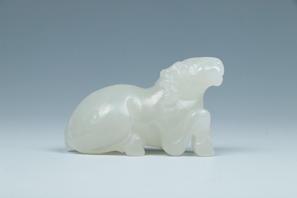 Appraisal: JADE CARVING OF A RAM Depicting a kneeling goat carving