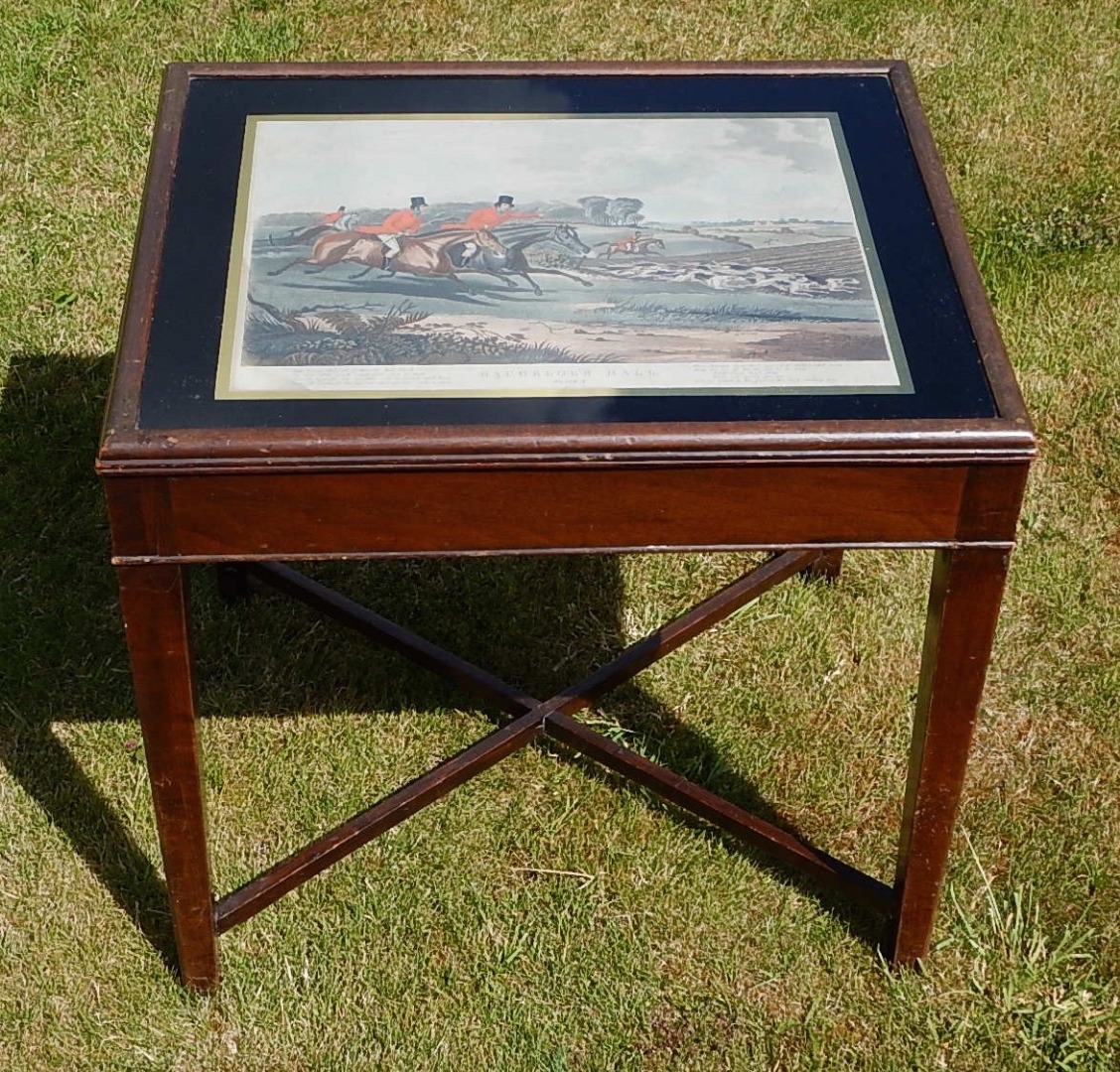 Appraisal: A mahogany rectangular coffee table the top with a hand