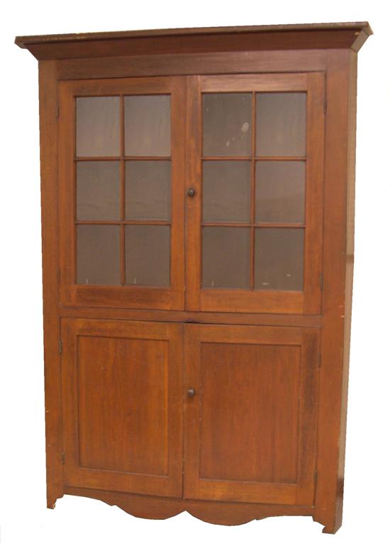 Appraisal: Corner cabinet American mid th C cherry with projecting cornice