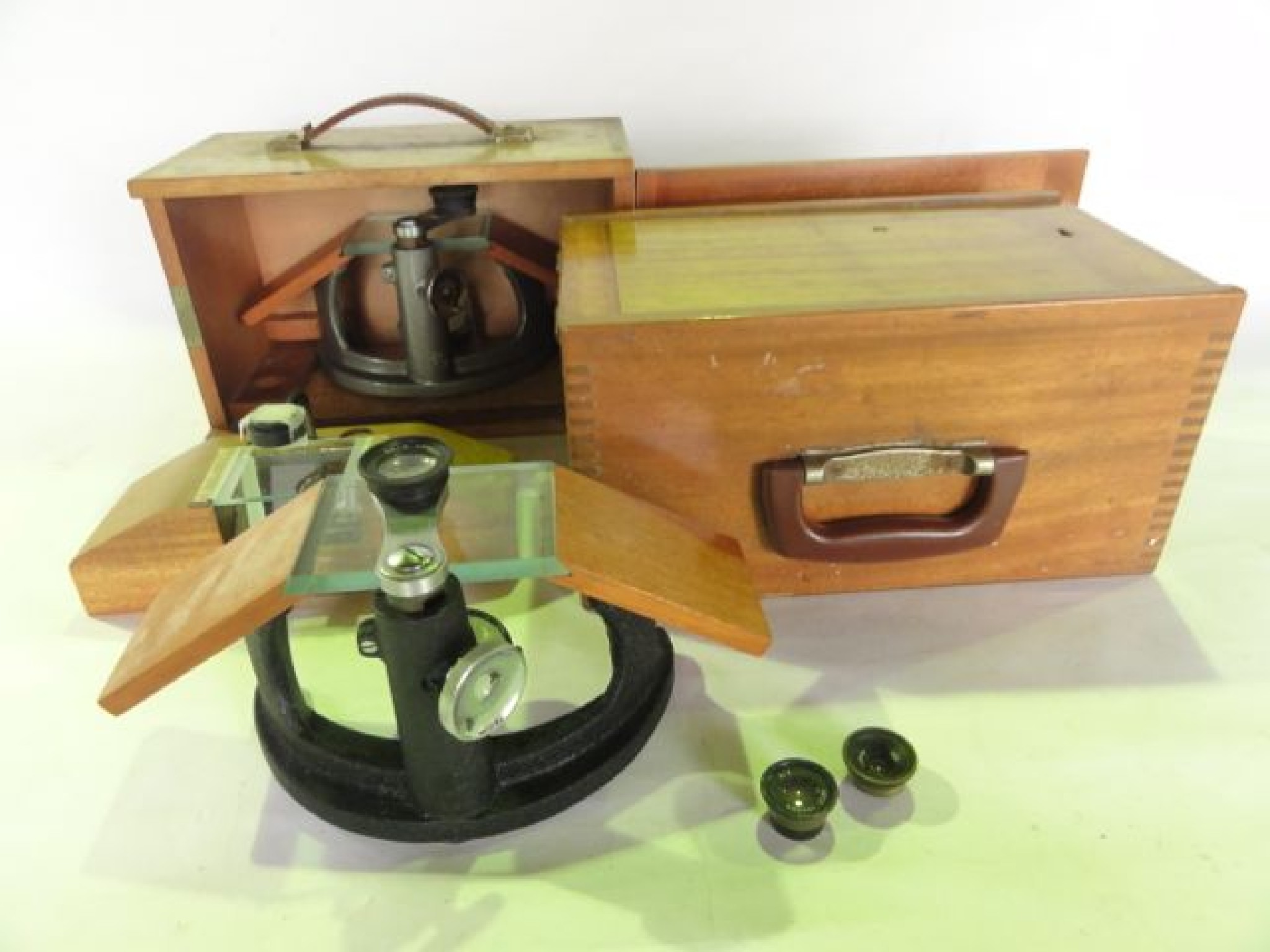 Appraisal: Two vintage timber cased microscope base assemblies one together with