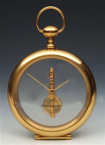 Appraisal: A JAEGER-LE-COULTRE BRASS AND GLASS DESK TIME PIECE with visible