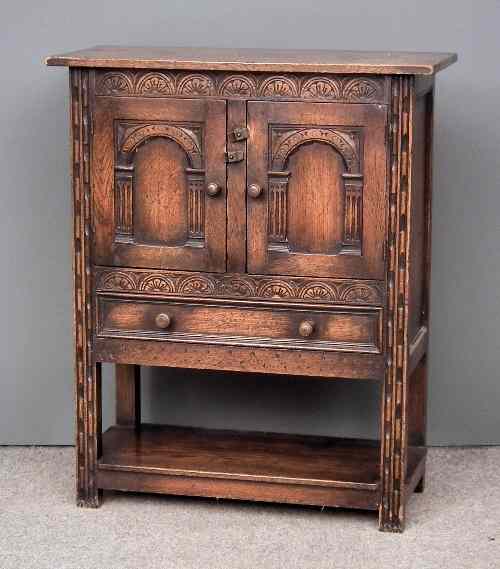 Appraisal: A panelled oak hall cupboard of '' th Century'' design