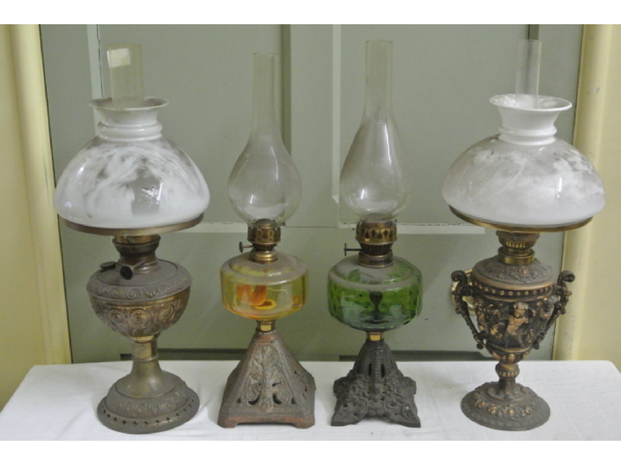 Appraisal: Four vintage oil lamps of varying design two with coloured