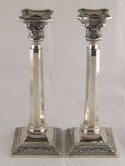 Appraisal: A pair of sterling silver candlesticks with octagonal columns rising