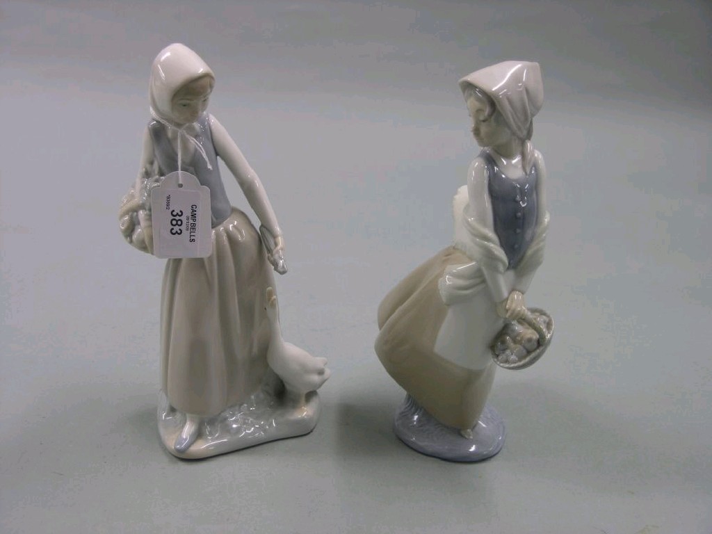 Appraisal: Two Nao porcelain figures girl with duck girl carrying basket