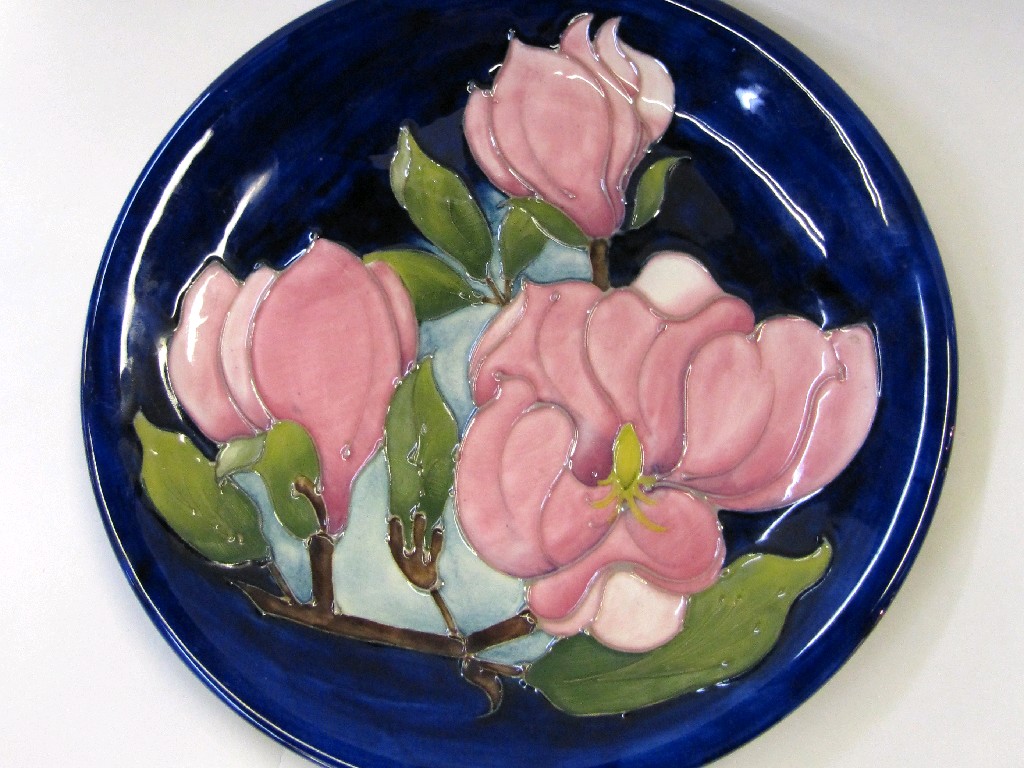 Appraisal: Moorcroft Magnolia pattern plate on blue ground