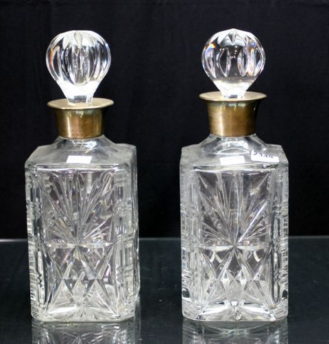 Appraisal: A pair of sterling silver mounted cut crystal decanters