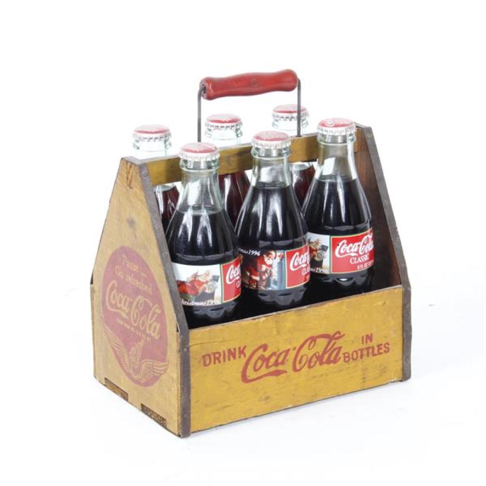 Appraisal: SIX COCA COLA BOTTLES IN YELLOW WOODEN CARRIER WITH RED