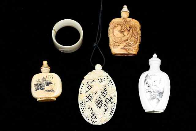 Appraisal: A CHINESE IVORY SNUFF BOTTLE AND STOPPER one side engraved