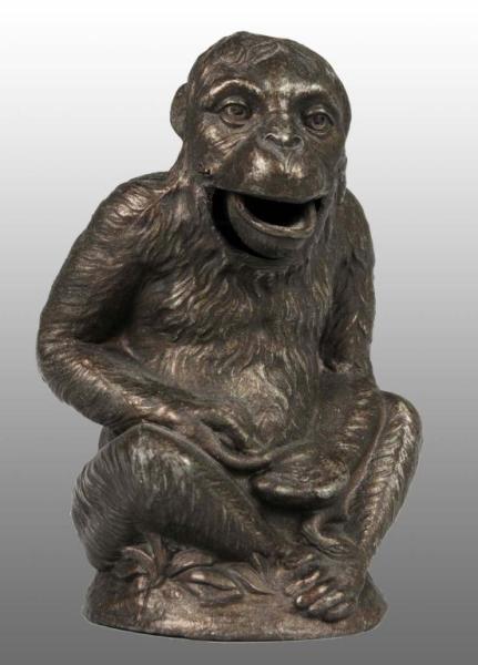 Appraisal: Cast Iron Chimpanzee Seated Mechanical Bank Description Manufactured in France