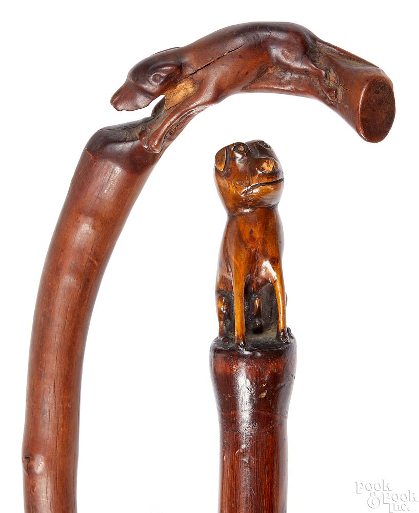 Appraisal: Two carved canes Two carved canes with dog grips l