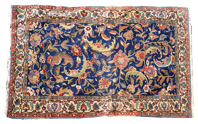 Appraisal: A TURKISH BLUE GROUND RUG with foliate decoration within a