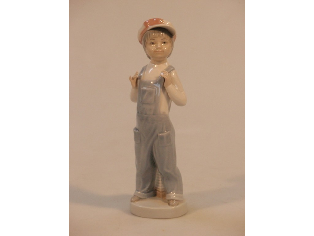 Appraisal: A Lladro figure of a young boy in dungarees and