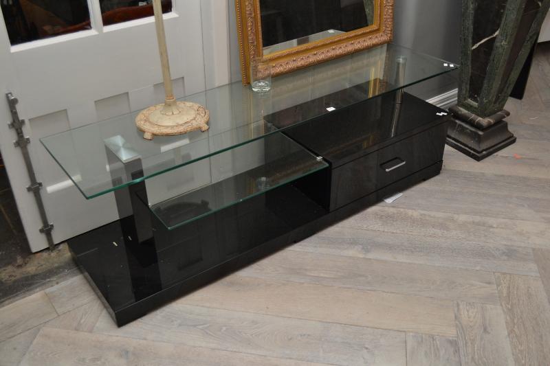 Appraisal: A CONTEMPORARY LOW BLACK TV UNIT WITH GLASS TOP A