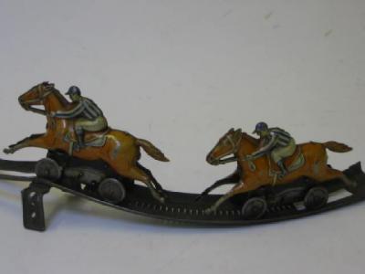 Appraisal: A Bavarian clockwork horse racing toy comprising circular track and