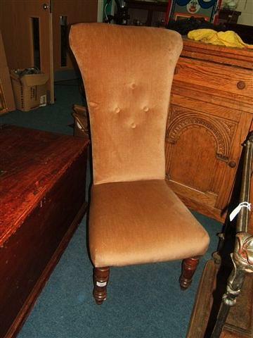 Appraisal: A Victorian mahogany high-backed nursing chair with turned front legs