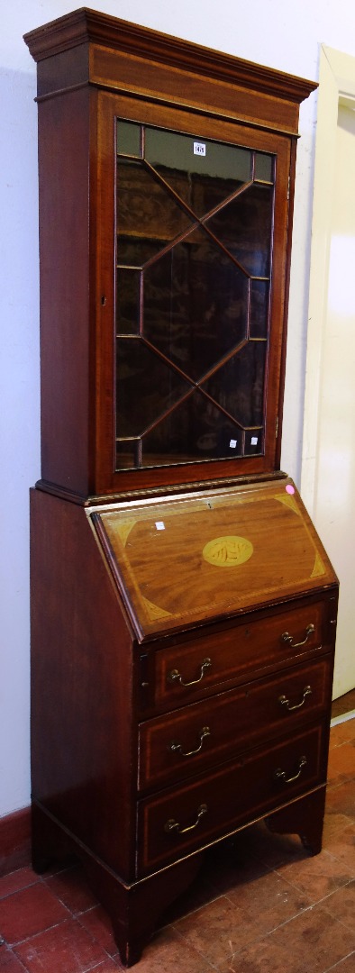 Appraisal: An Edwardian inlaid mahogany bureau bookcase the single glazed door