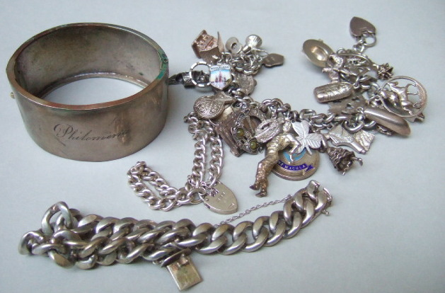 Appraisal: A curb link charm bracelet on a silver heart shaped