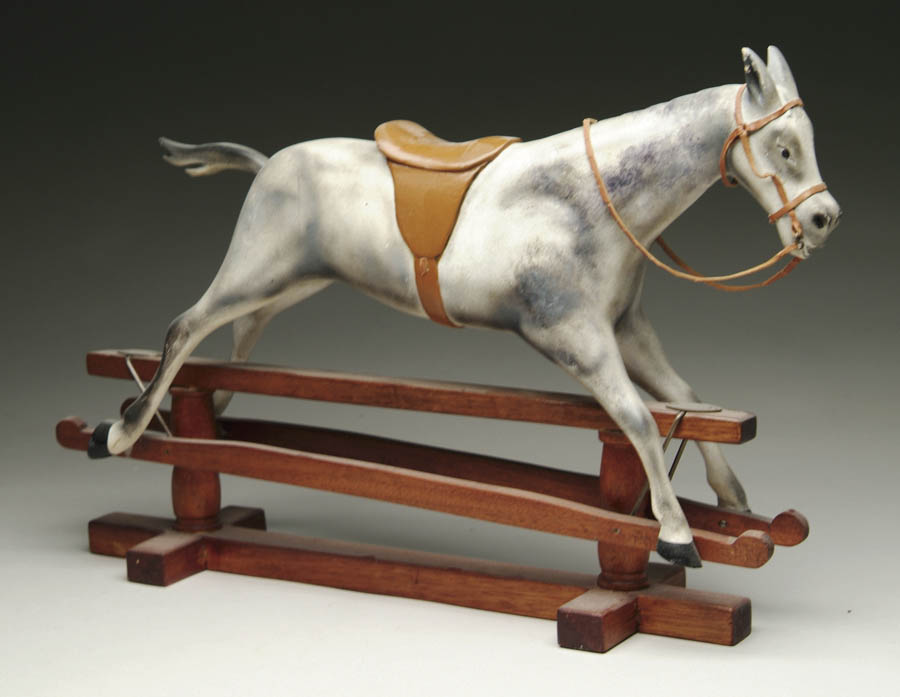 Appraisal: MINIATURE WOODEN ROCKING HORSE This dappled gray horse with painted