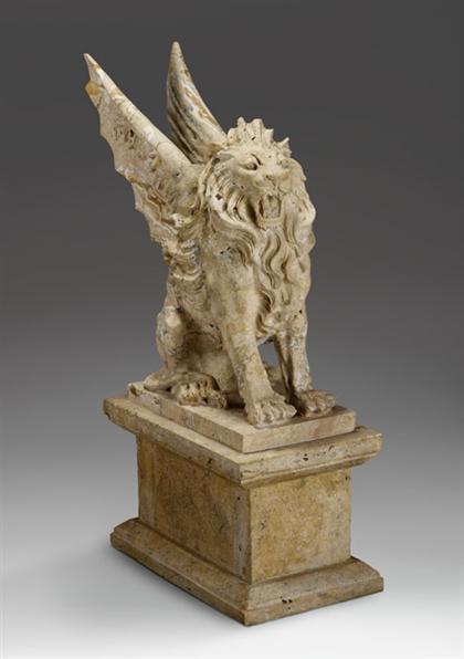 Appraisal: Carved travertine figure of a winged lion Seated with wings