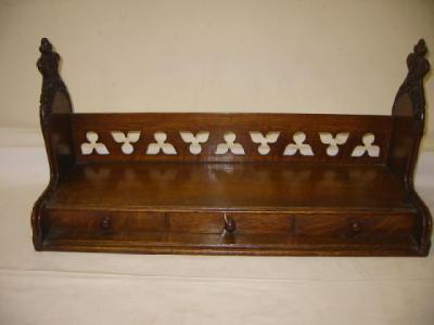 Appraisal: A VICTORIAN GOTHIC OAK BOOK TROUGH of stepped oblong form