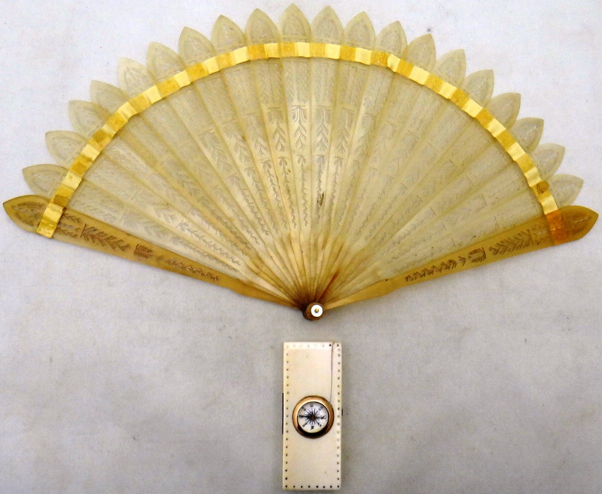 Appraisal: A folding horn fan with pierced decoration and a rectangular