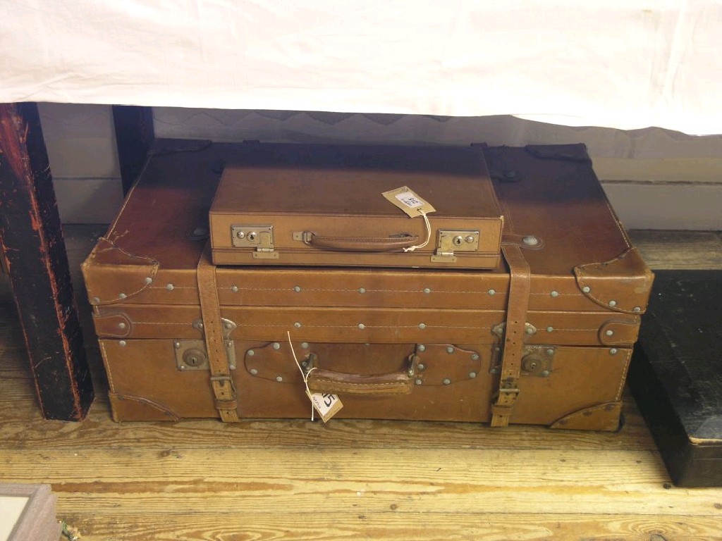 Appraisal: An early th century leather suitcase and a small brown