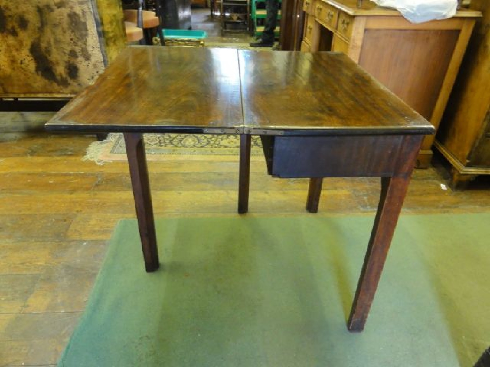 Appraisal: A small Georgian mahogany tea table of rectangular form raised