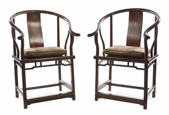 Appraisal: A Pair of Chinese Horseshoe-Back Armchairs having yokebacks constructed from