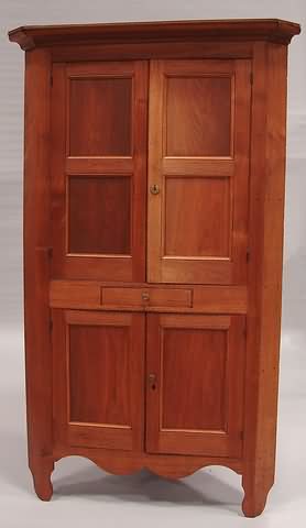 Appraisal: Walnut two over two doors divided by a single drawer