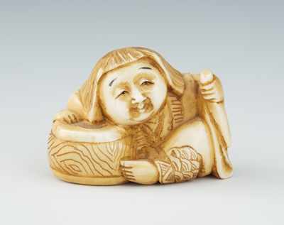 Appraisal: A Carved Ivory Netsuke of a Seated Woman Carved seated