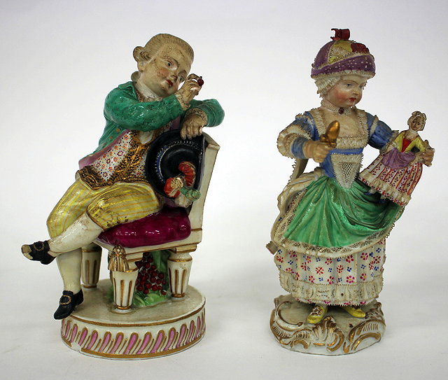 Appraisal: A MEISSEN FIGURINE of a girl standing holding a doll