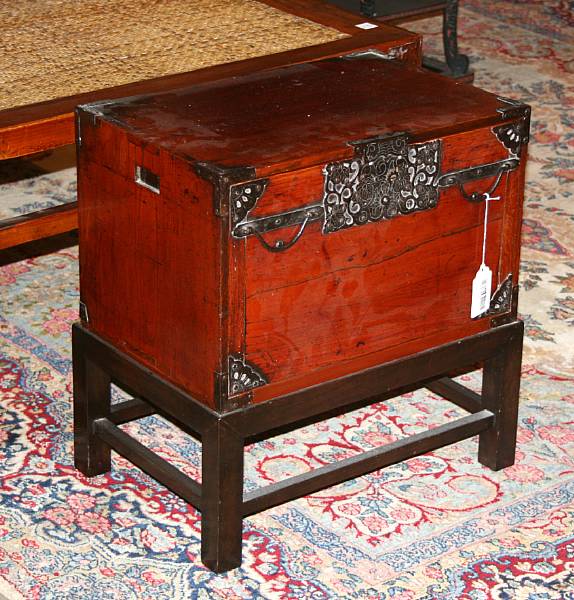 Appraisal: A small Japanese mixed wood merchant's chest on later wood