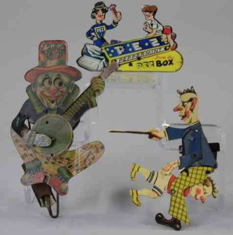 Appraisal: LOT OF THREE HAND HELD TOYS Lithographed tin includes a