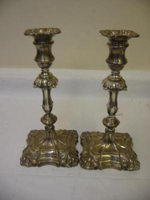 Appraisal: A PAIR OF CANDLESTICKS of squared form with anthemion moulded