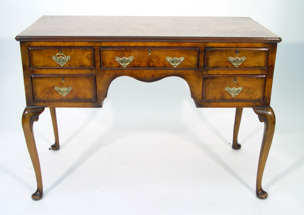 Appraisal: Walnut kneehole dressing table fitted an arrangement of five drawers