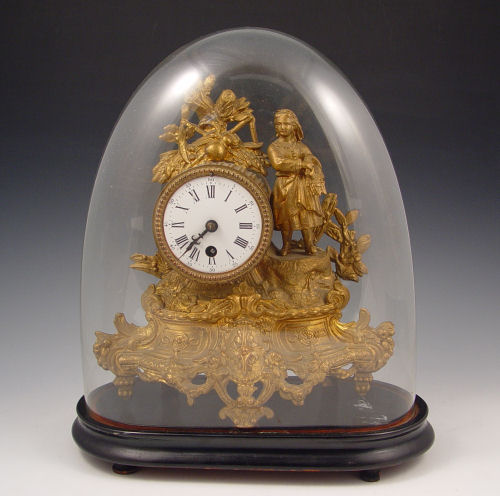 Appraisal: FRENCH FIGURAL CLOCK UNDER GLASS DOME Bronzed metal finish with