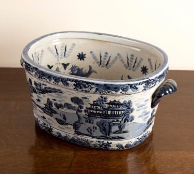 Appraisal: A large blue and white willow pattern two-handled foot bath