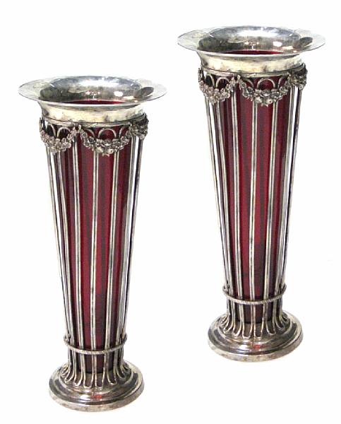 Appraisal: A pair of silvered and bronzed urns with glass liners