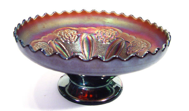 Appraisal: Purple Carnival glass pedestal bowl moulded with flowers to the